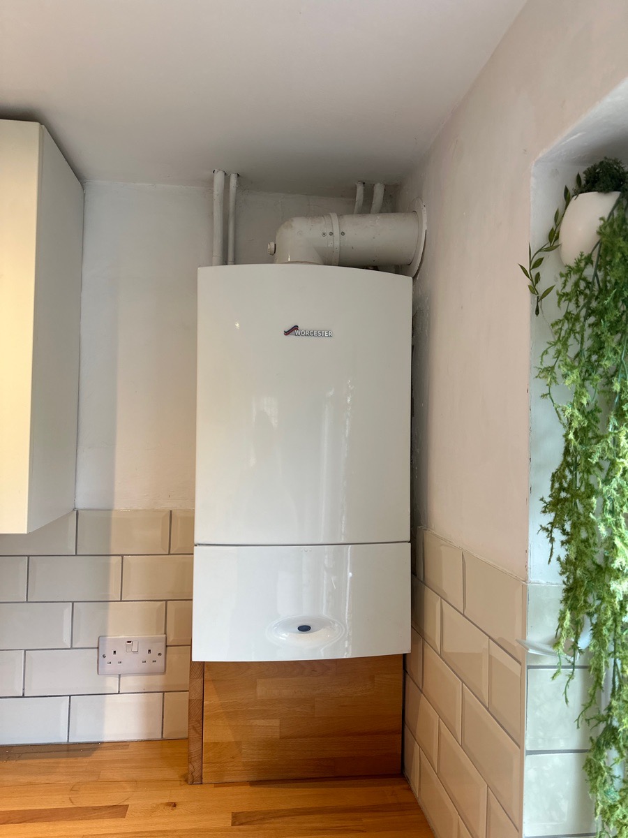 Worcester combi boiler installed in a tiled kitchen corner