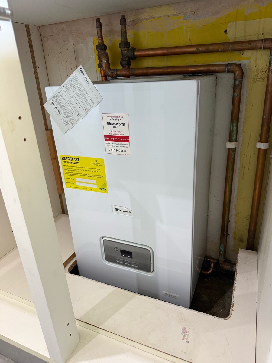 New Glow-worm boiler installed under a worktop with fresh copper pipework