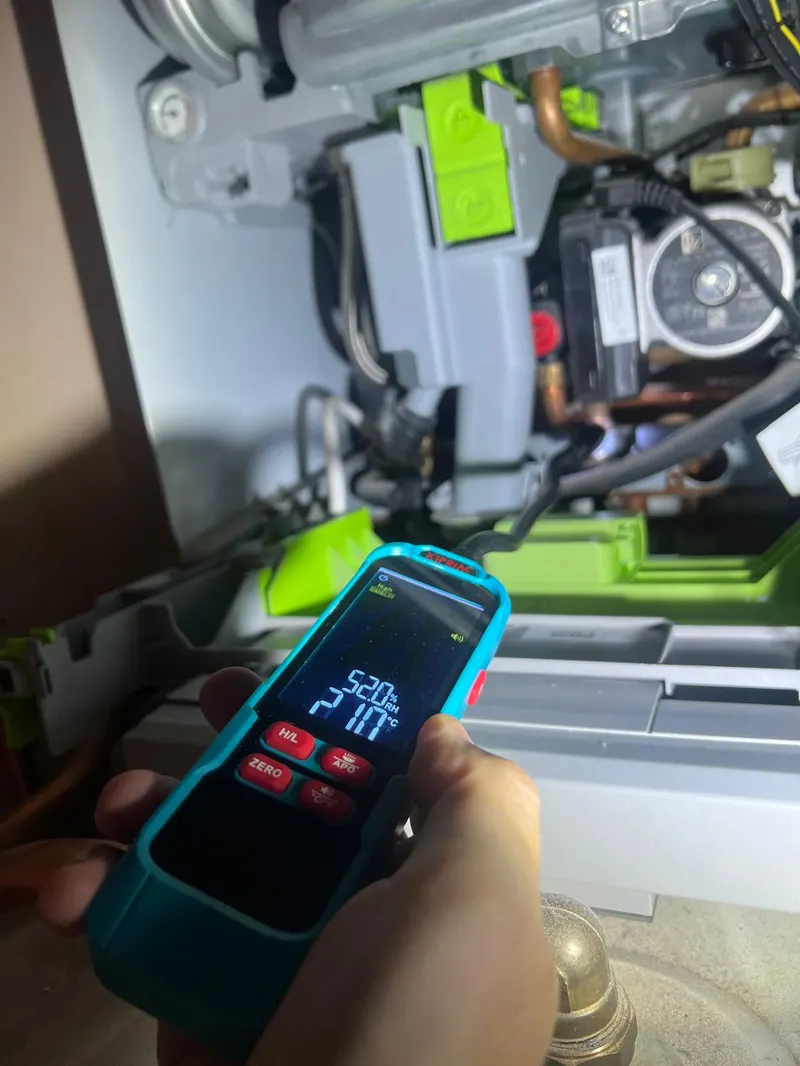 Engineer carrying out a flue gas analysis during a boiler service