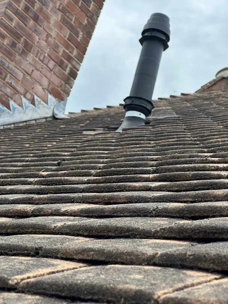 New boiler flue terminal fitted through a tiled roof