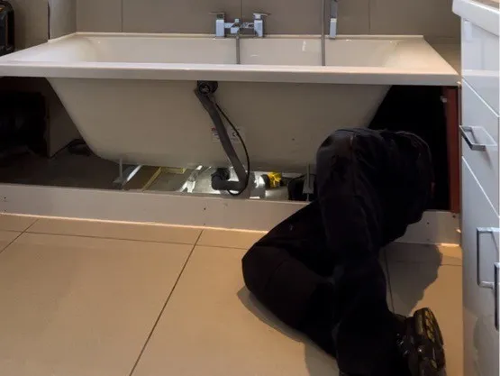 One of our engineers at work fitting a bath
