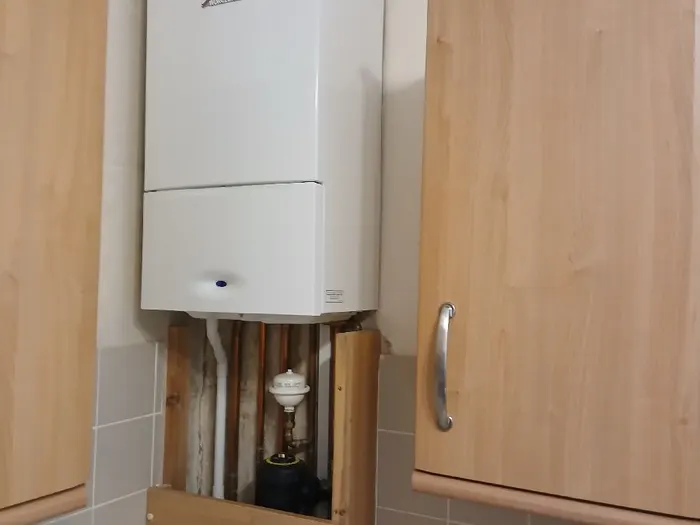 Worcester boiler housed neatly inside an oak kitchen cupboard