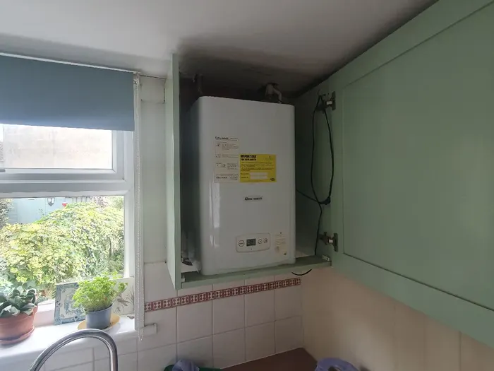 Boiler installed in a kitchen with the window and worktop in view