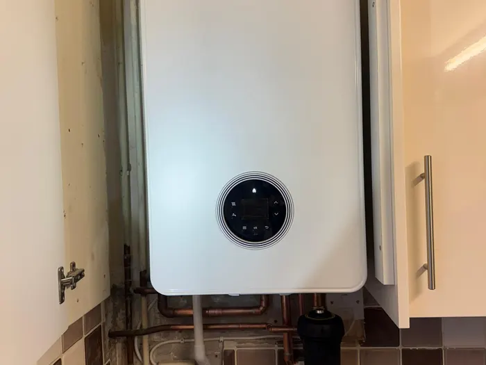 Worcester combi boiler fitted beside kitchen units above a tiled floor