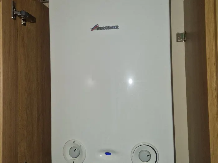 Worcester boiler fitted tidily inside an oak kitchen cupboard