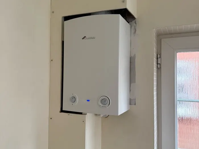 Worcester boiler on a utility wall beside a glazed back door