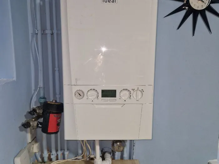 Ideal boiler fitted on a blue wall above a wood floor