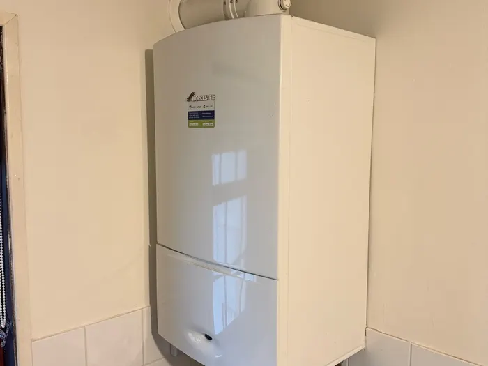 Clean Worcester boiler above a tiled splashback in a bright corner